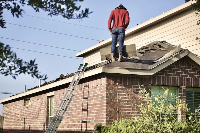 Professional roofer working on a residential roof in Dolington